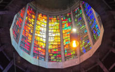 The lantern at Liverpool Metropolitan Cathedral Looking up into a circular space surrounded by stained glass windows