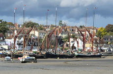 A typical view of the town Looking at a town on the banks of a river at low tide, with Thames sailing arges moored at the quay