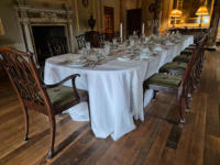 The dining table in Basildon Park A long dining table with elaborate place settings