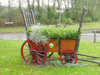 A model hay wain containing flowers