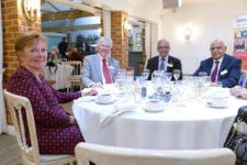 Four people sitting at a dining table